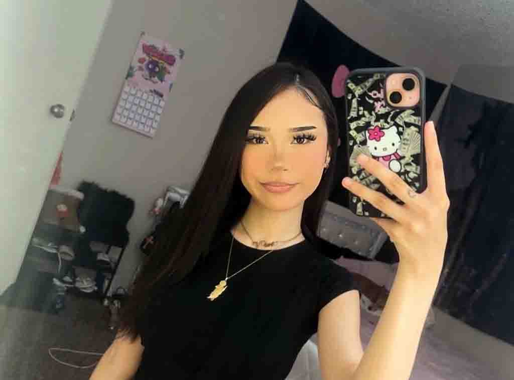 Vivi2freaky posing with her signature vampire teeth and long black hair in a high-quality close-up.