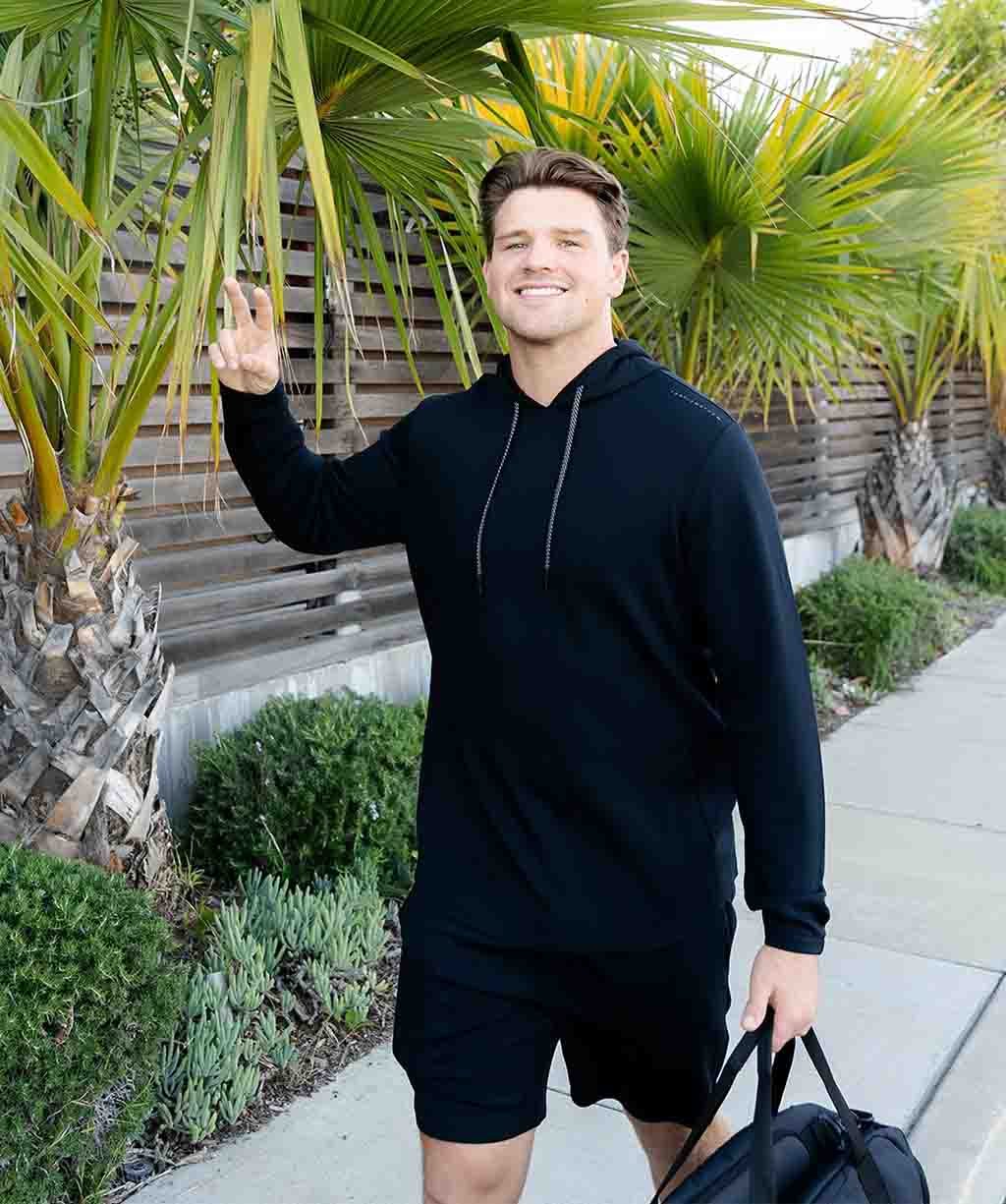 Walker Lyons posing casually in a black hoodie in California, reflecting his Folsom High roots.